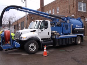 The Sewer Dept operates their Flusher Truck to keep storm drains clean.